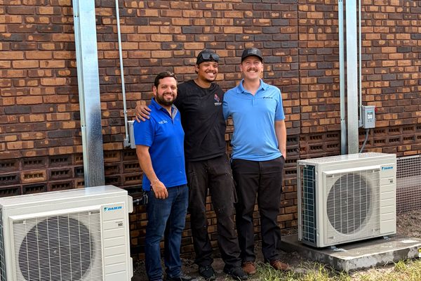 North East Heating And Cooling crew with two new Daikin condensers at Powell Middle School